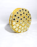 Round GOLDEN  yellow CLUTCH BAG with floral patterns on a white background