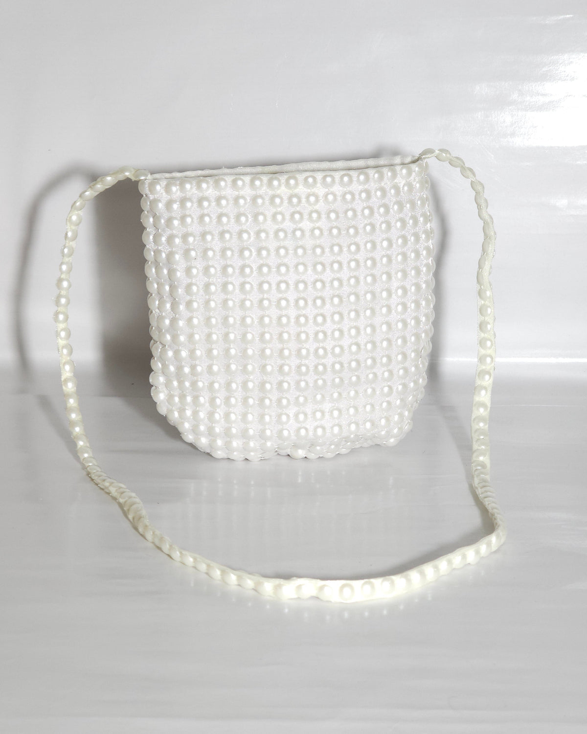 White pearl-handled bag on a white background
